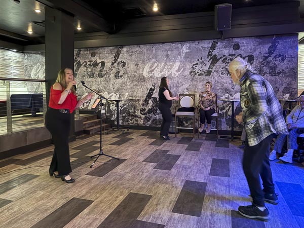 lady singing and elderly lady dancing