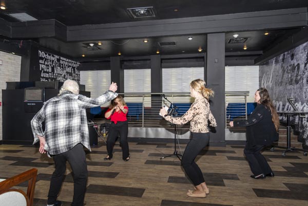 lady singing and elderly couple dancing