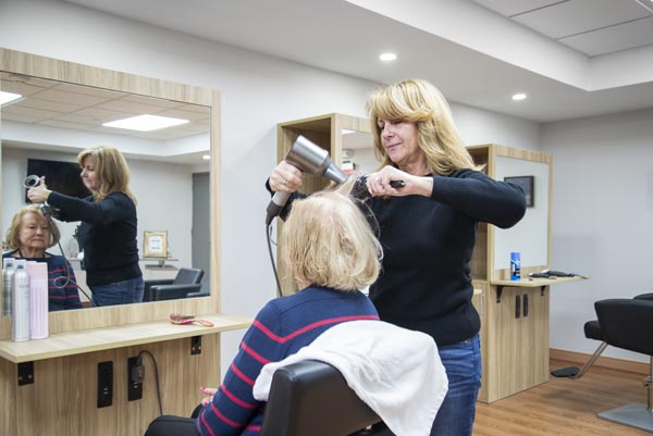 elderly lady getting her hair done at salon