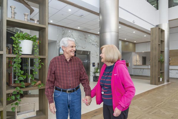 Two Elderly Residents Share a Candid Moment at Courtyard Luxury Senior Living