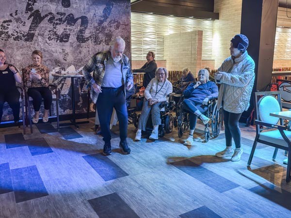 An Old Man Dancing in front of people in Courtyard Senior living in Clinton, NJ