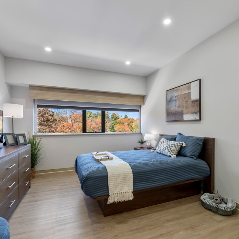 Elegant senior bedroom with soft lighting at Courtyard Luxury Senior Living