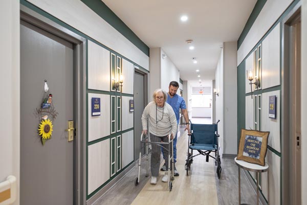 elderly woman walking with walker