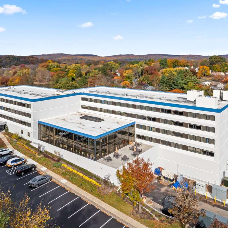 Aerial view of the Courtyard Luxury Senior Living property and green landscape