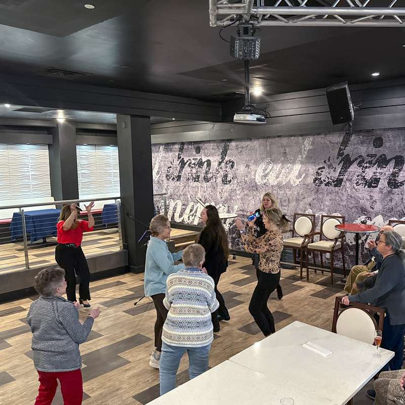 Seniors enjoying a social event at Courtyard Luxury Senior Living in Clinton, NJ