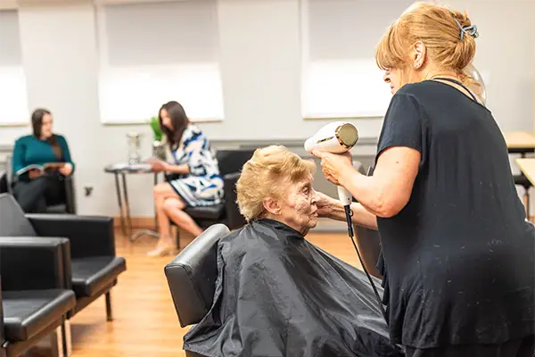 Resident getting her hair styled at the on-site Courtyard salon