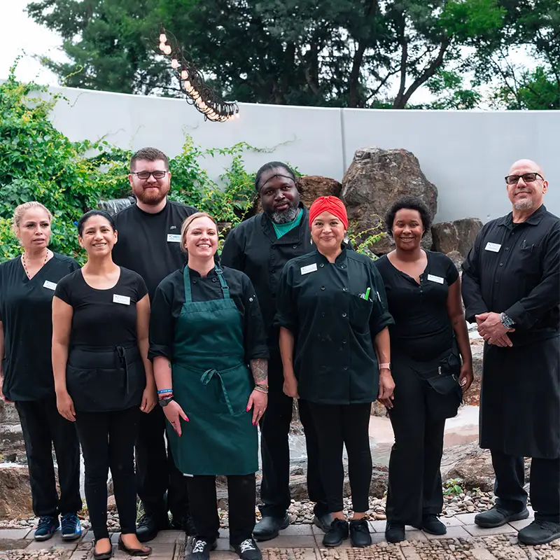 The Courtyard care and dining team standing together in the garden