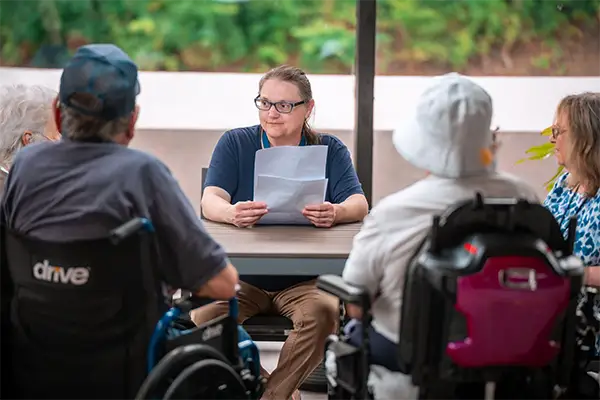 Courtyard team member leading a small-group activity with residents